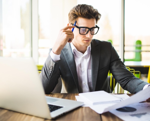 Image of a business person looking through invoices.