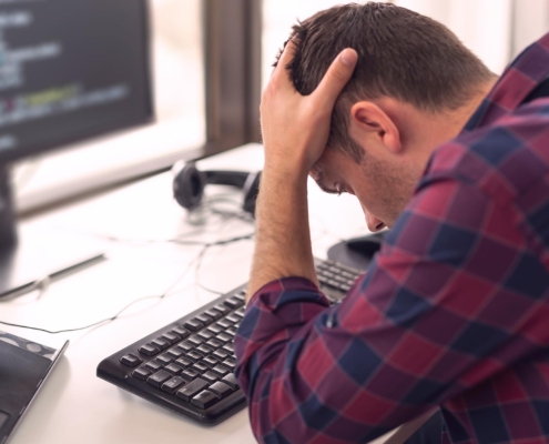Image of a person frustrated with a computer.