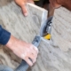 Artisan cuts edges in marble kitchen countertop with hand circular saw