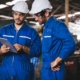 Two workers in the field looking at tablet