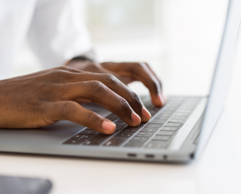 Side view of someone using a laptop