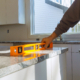 Under construction with worker checks the leveling of a granite slab for use a home kitchen remodel