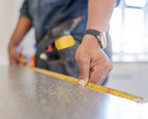 Carpenter, work table and measure tape with hands