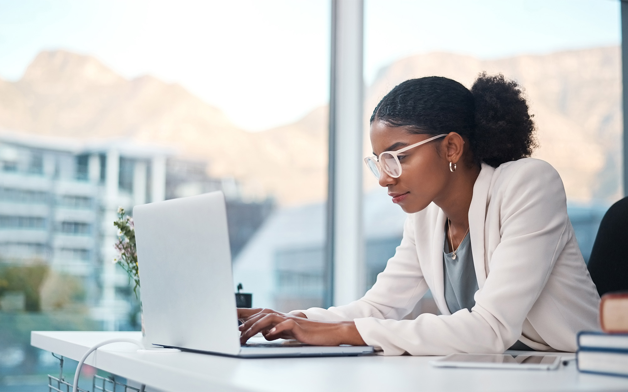 Side view of woman in modern office typing on computer